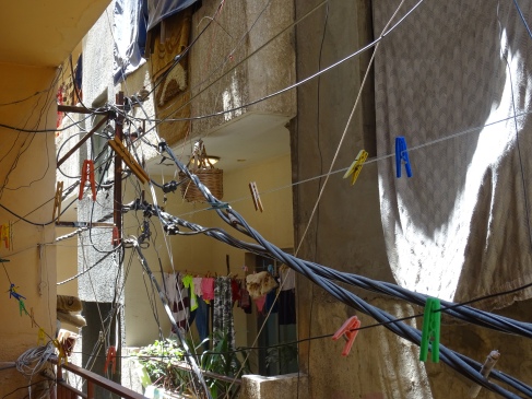 Making it work: Electricity cables and clothes lines over one of the alleyways in Baddawi refugee camp (Lebanon). (c) Fiddian-Qasmiyeh.